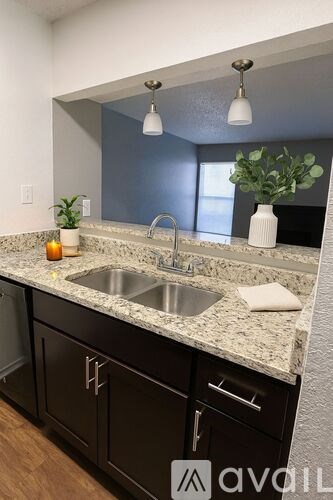 A kitchen with a granite countertop and a sink.