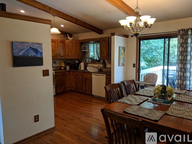 A dining room with a wooden table and chairs.