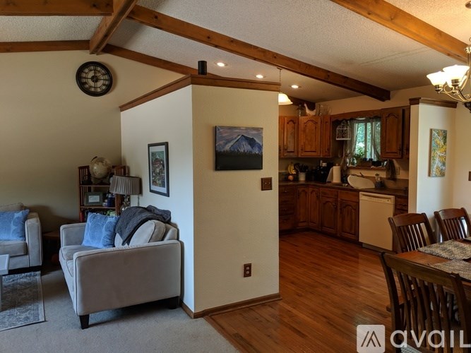 A living room with a couch and a painting on the wall.