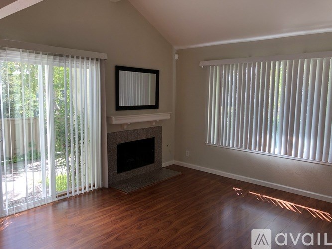 A room with a fireplace and a picture frame on the wall.