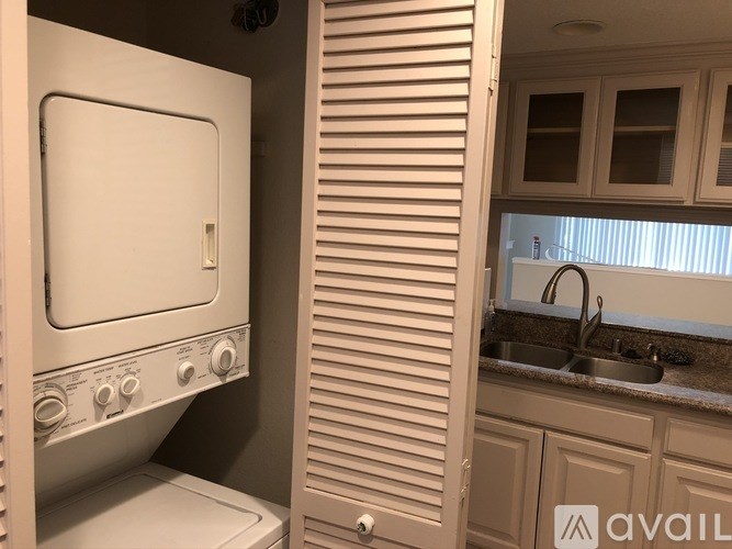 A white oven in a kitchen with wooden cabinets.