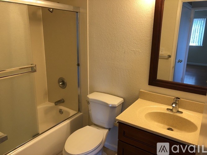 A bathroom with a toilet, sink, and shower.