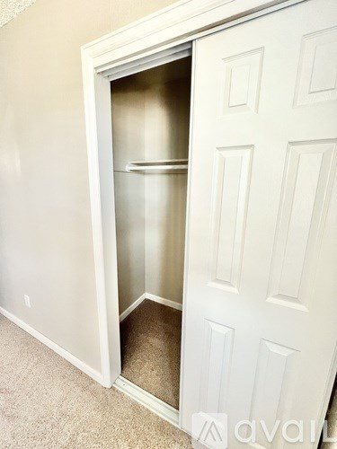 A white door with a glass panel is open.