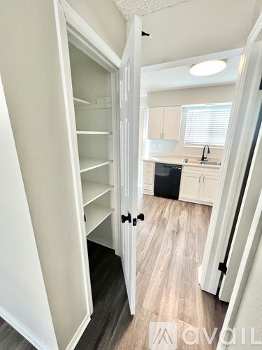 A white refrigerator with its door open in a kitchen.