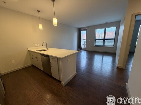 A kitchen with white cabinets and a countertop is shown.