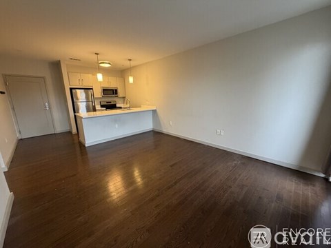 A kitchen area with a refrigerator, microwave, and oven.