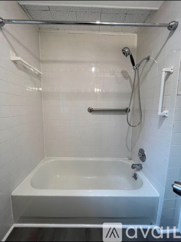 A white bathroom with a bathtub and shower.