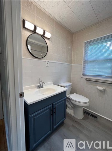 A bathroom with a white sink and a toilet.