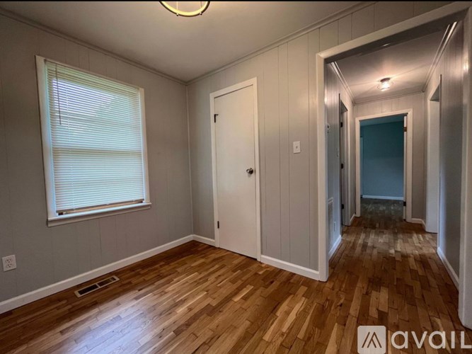 A room with wooden floors and a white door.