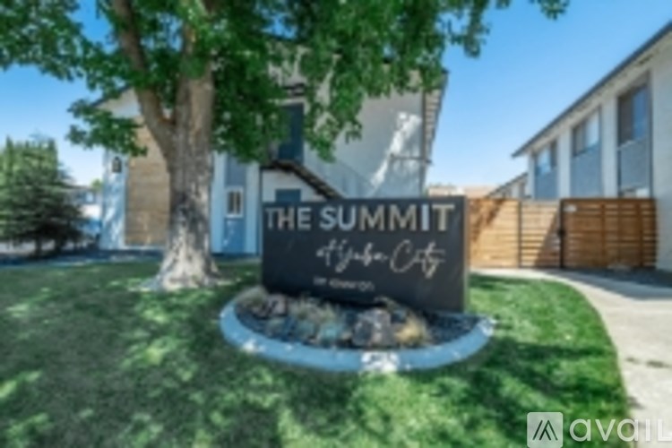 A sign that says "The Summit" stands in front of a building.