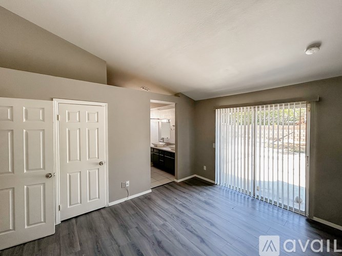 A room with a sliding glass door leading to a balcony.
