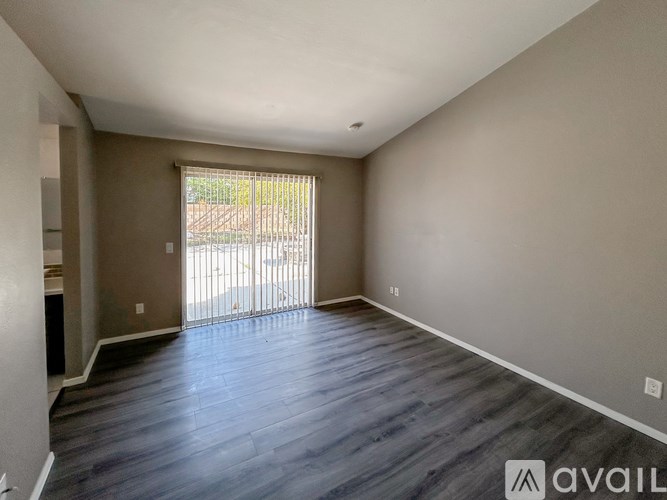 A room with a sliding glass door leading to a backyard.