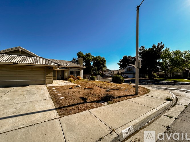 A house with a brown roof and a driveway in front of it.
