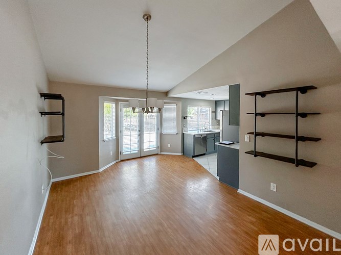 A room with wooden floors and a large window.
