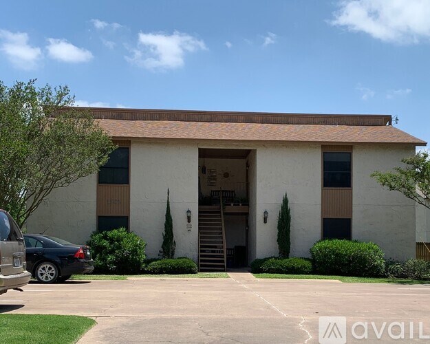 A building with a car parked in front of it.