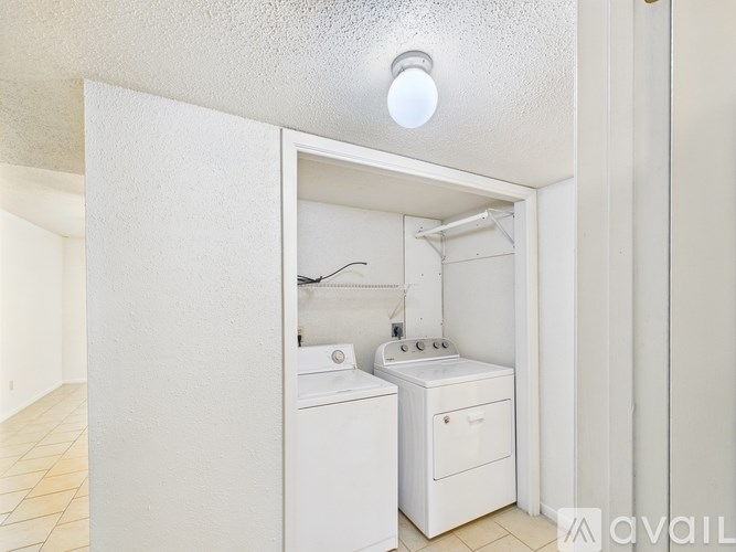 A small white bathroom with a toilet, sink, and a light on the ceiling.