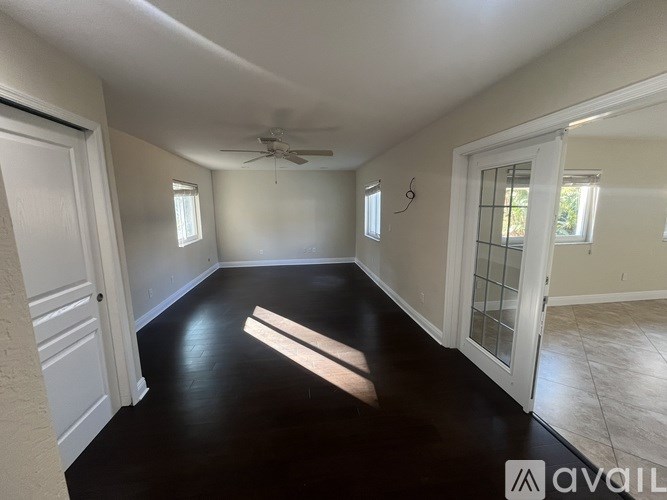 A room with a black floor and white walls.