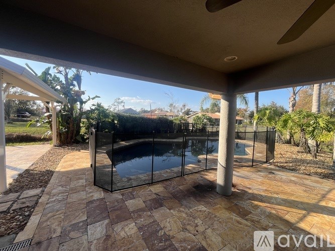 A glass enclosed hot tub sits on a patio.
