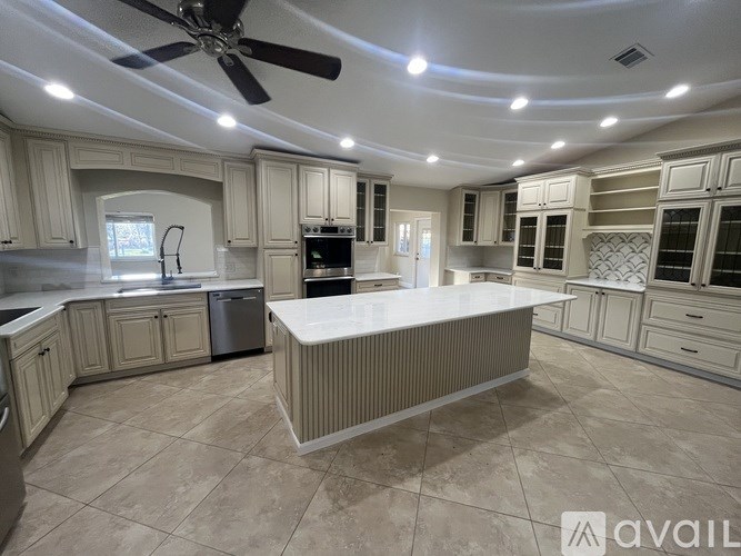 A spacious kitchen with a large island in the center.