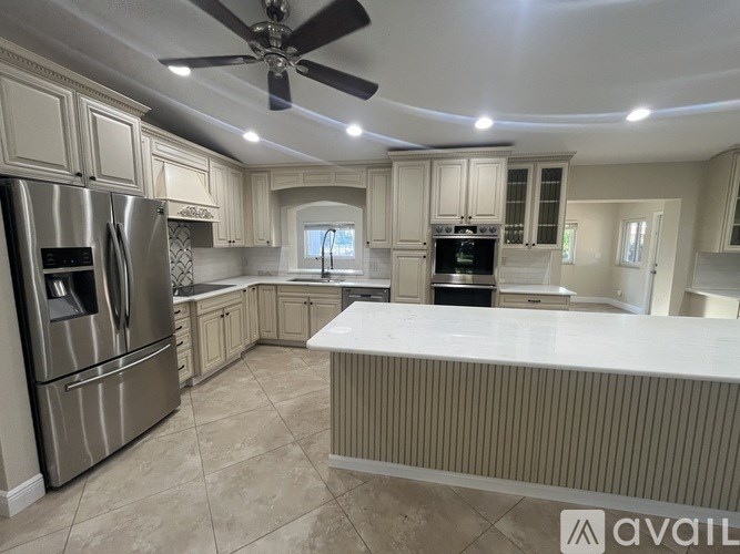 A kitchen with a refrigerator, stove, and oven.