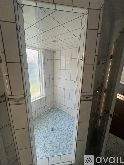 A bathroom with a blue and white tiled floor.