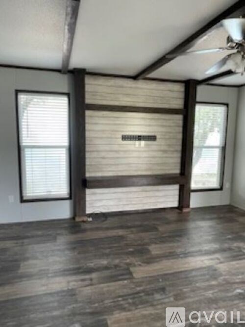 A room with wooden floors and a sliding door.