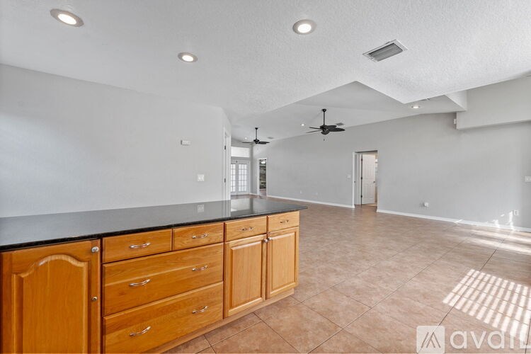 A kitchen with wooden cabinets and a countertop.