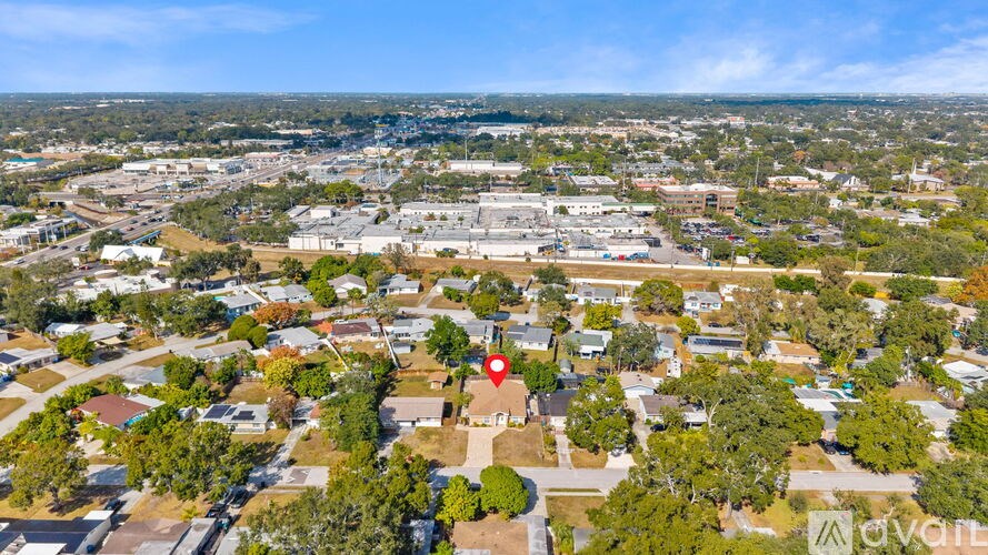 A bird's eye view of a residential area with a red marker indicating a specific location.