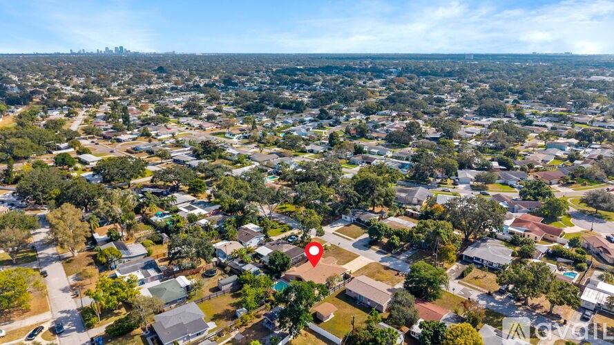 An aerial view of a residential area with a red marker indicating a specific location.