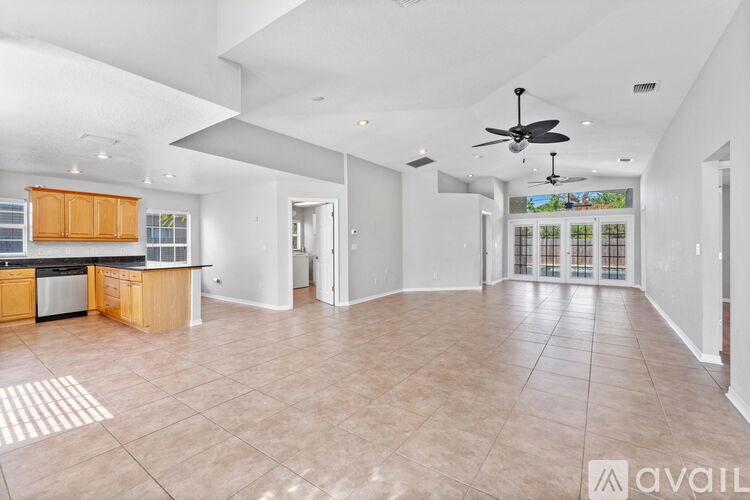 A spacious kitchen with wooden cabinets and a black countertop.