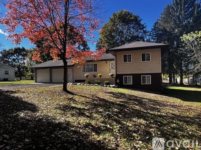 A house with a tree in front of it.