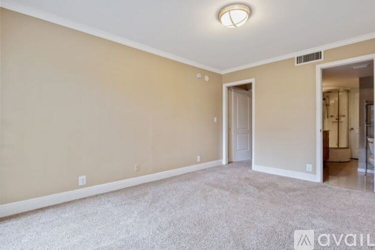 A room with beige walls and a carpeted floor.