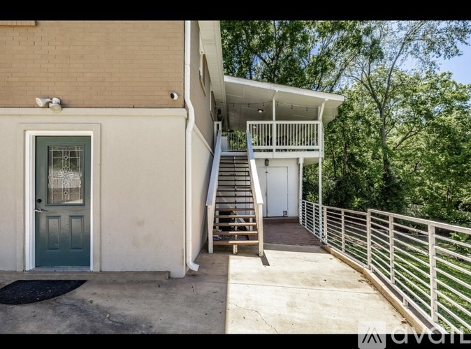 A house with a balcony and stairs leading to the second floor.