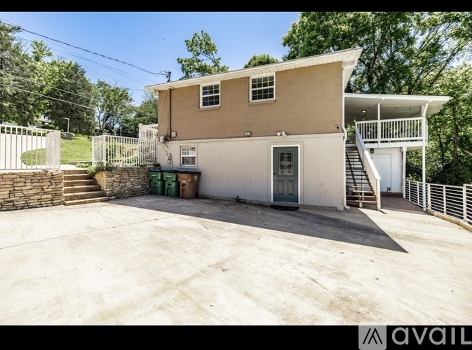A two-story house with a garage and a deck.