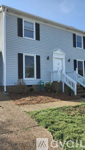 A house with a white door and black shutters.
