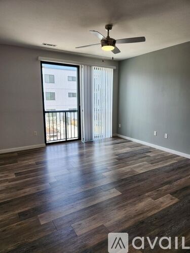 A room with wooden flooring and a ceiling fan.