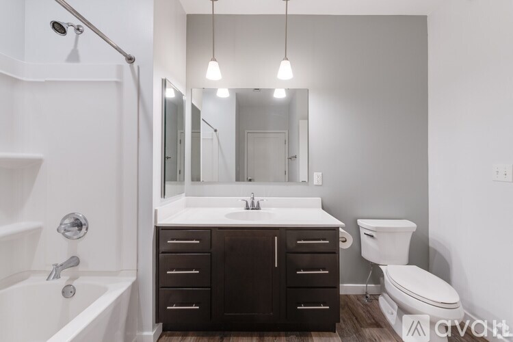 A bathroom with a white sink and a white toilet.