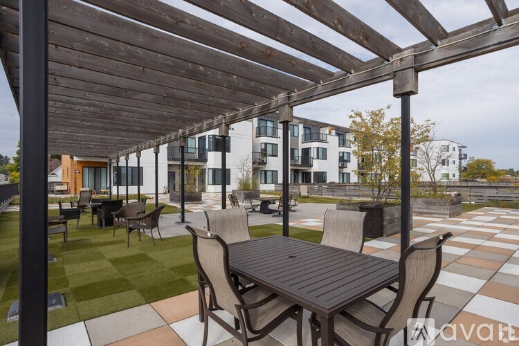 A wooden pergola over a table set for four.