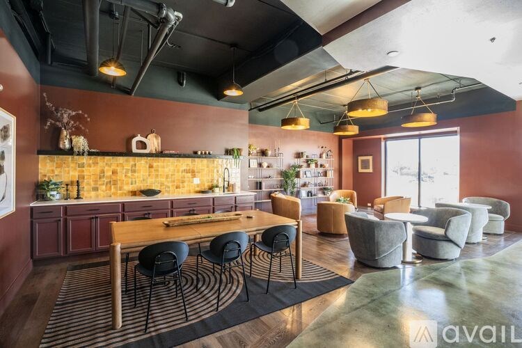 A modern kitchen with a dining table and chairs.