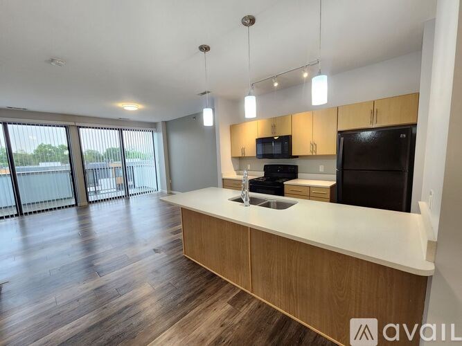 A modern kitchen with wooden cabinets and a white countertop.