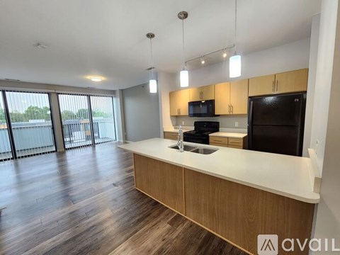 A modern kitchen with wooden cabinets and a white countertop.