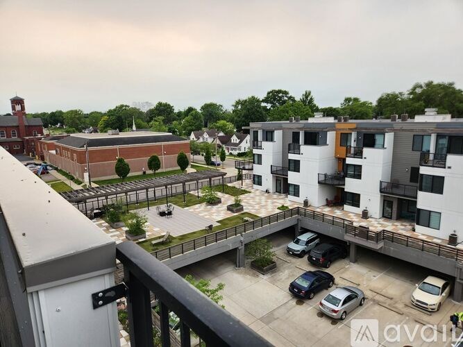 A view of a parking lot with cars and apartment buildings.