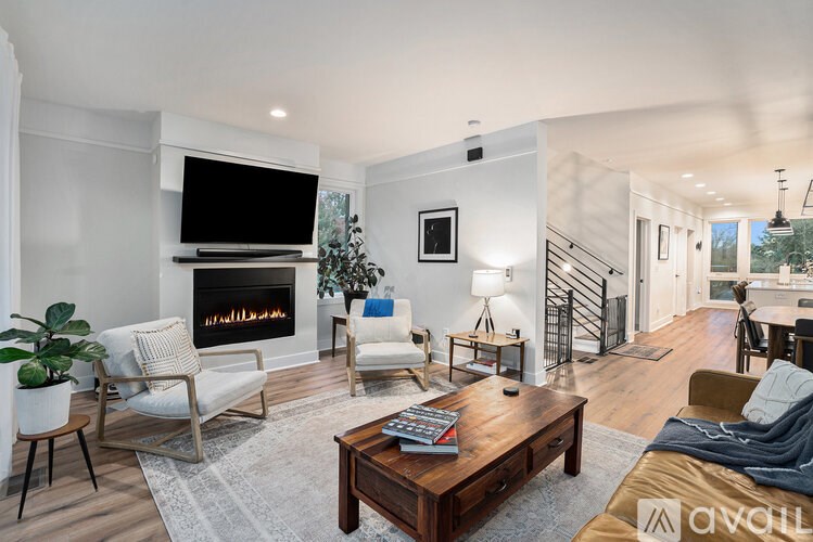 A modern living room with a fireplace and a television.