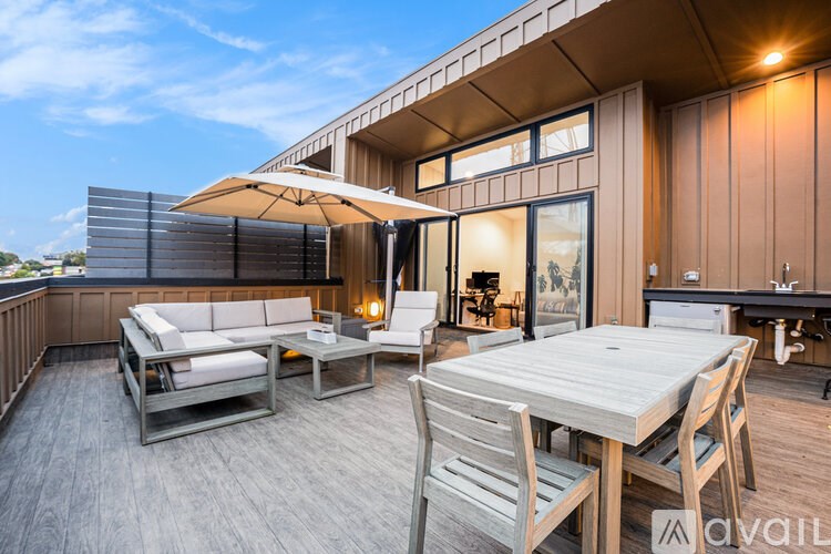 A wooden deck with a table and chairs is available for rent.