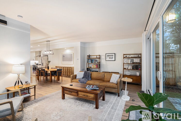 A living room with a couch, coffee table, and bookshelf.