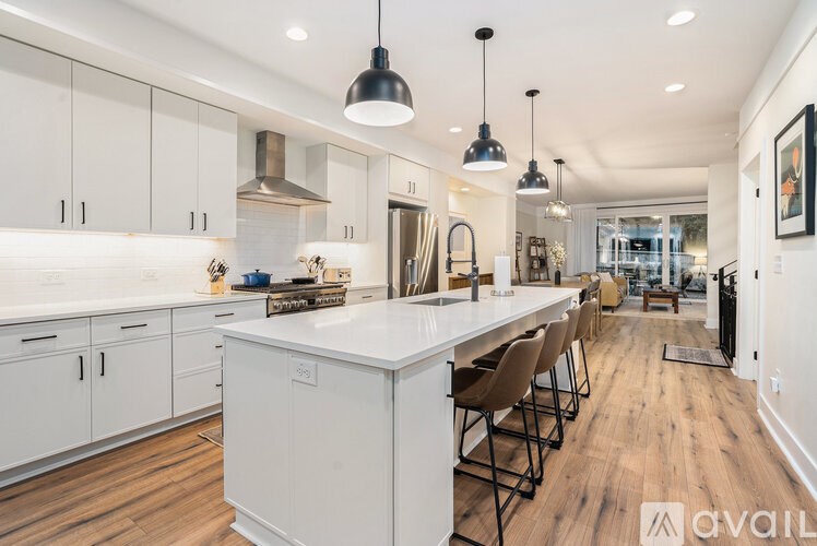 A modern kitchen with white cabinets and a central island.