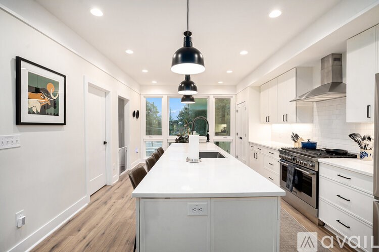 A modern kitchen with white cabinets and a large island.
