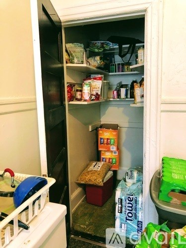 A small open refrigerator is full of food and drinks.