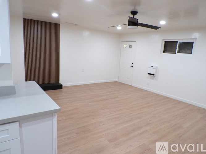 A room with a ceiling fan and lighting fixtures.