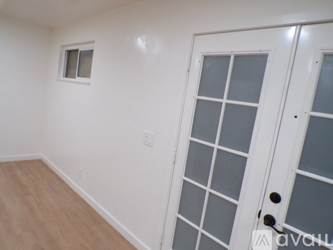 A room with a white door and a window.